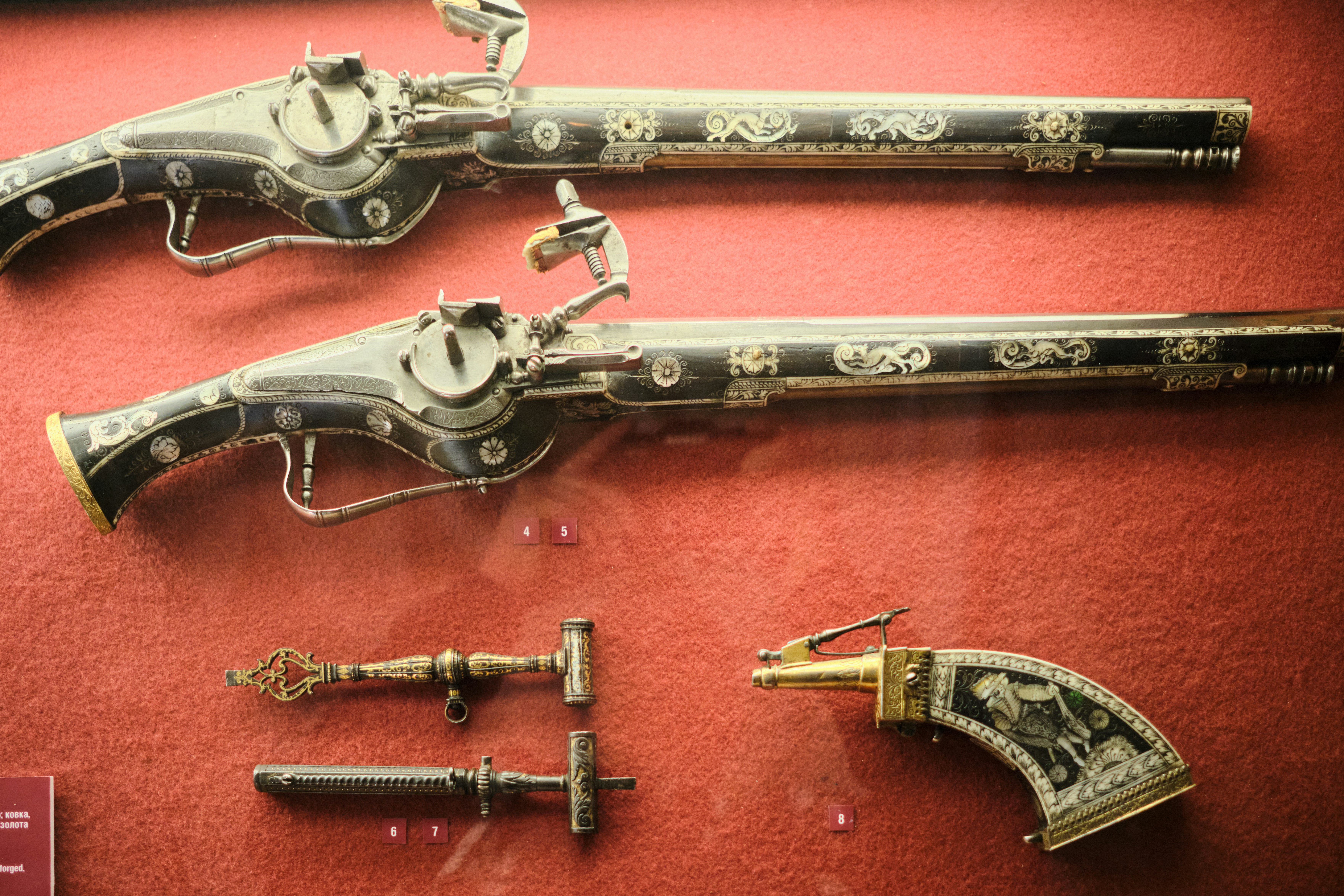 Antique pistols and tools are on display.